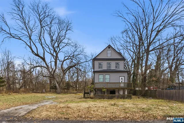 a front view of a house with a yard covered with snow in front of house