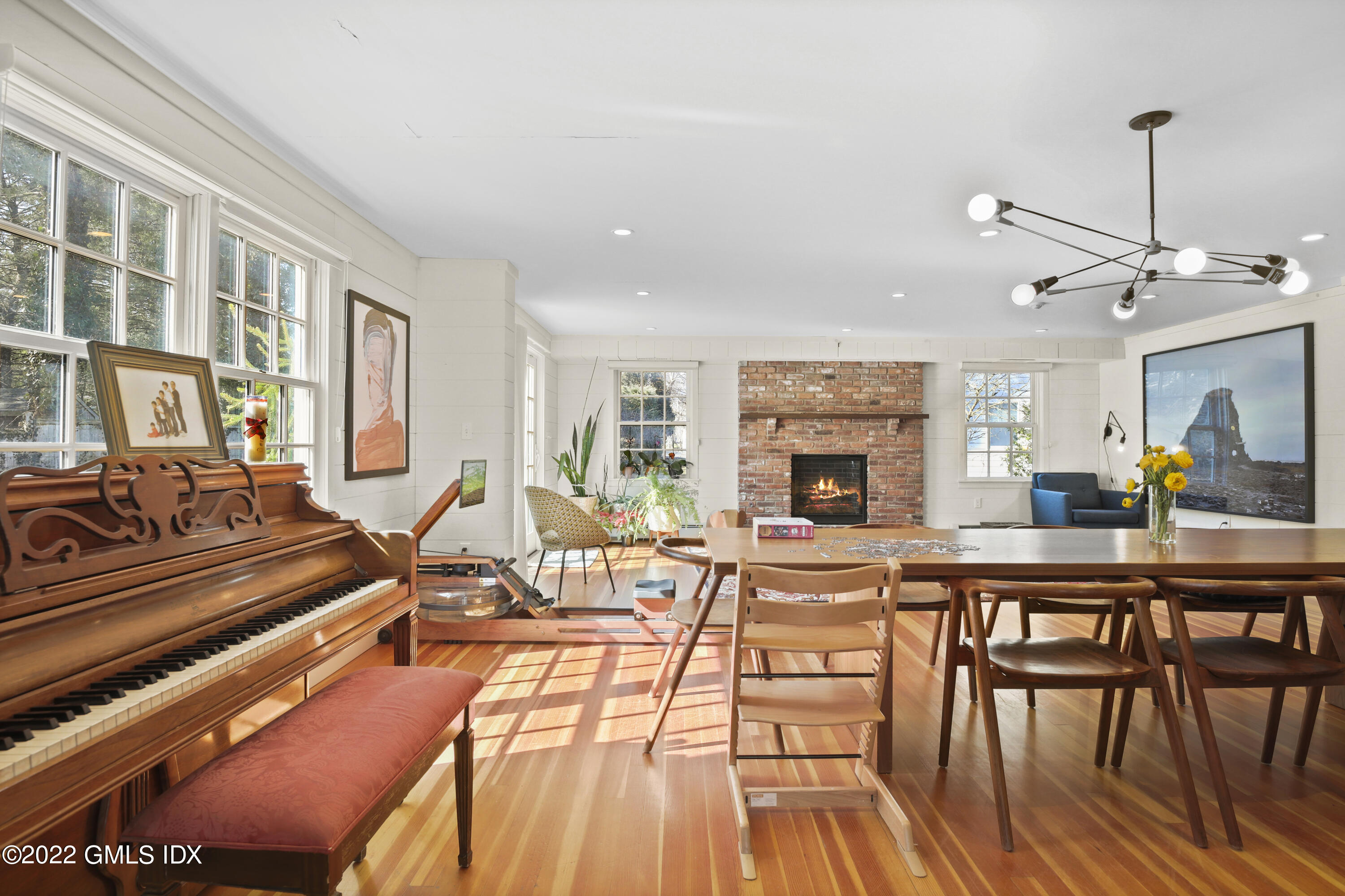17 Tory Road Riverside, CT 06878 - Photo 5 of 19 a living room with furniture a fireplace and a dining table with wooden floor