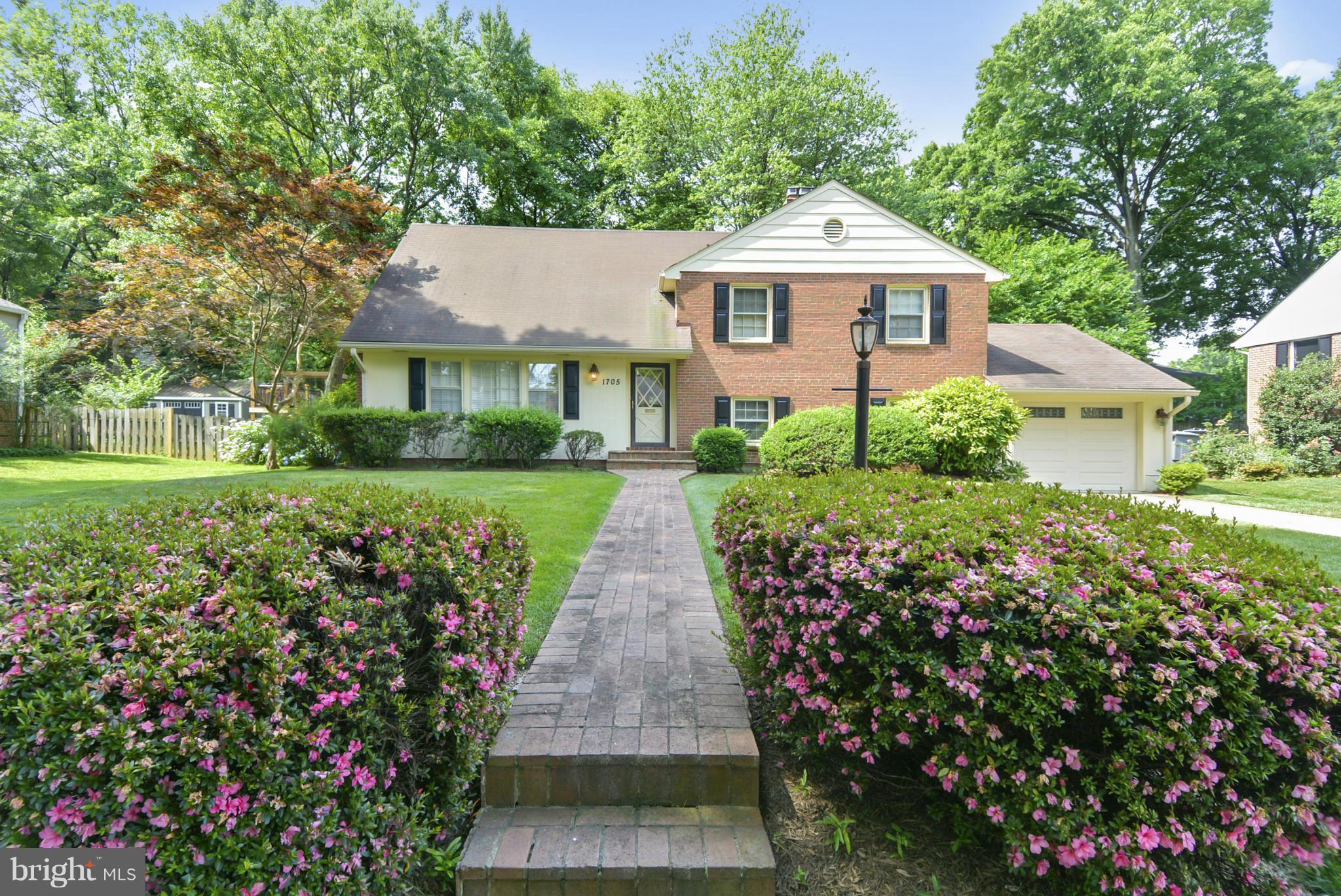 1705 Old Stage Road Alexandria, VA 22308 - Photo 1 of 23 a front view of a house with a yard and fountain in middle