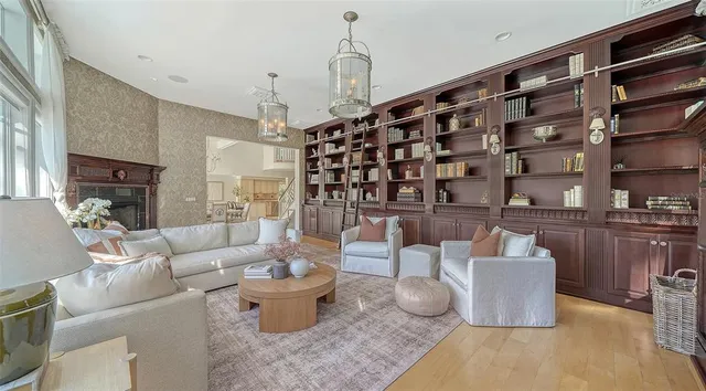 a view of a balcony with chairs and wooden fence