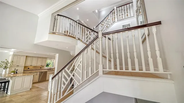 a bedroom with a large bed and a chandelier