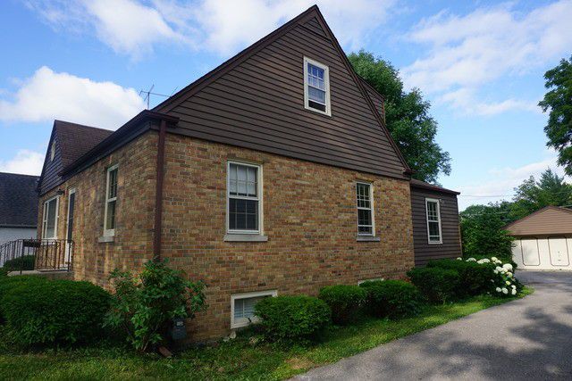 324 South Maple Street Itasca, IL 60143 - Photo 2 of 21 a front view of a house with garden