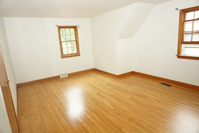 324 South Maple Street Itasca, IL 60143 - Photo 11 of 21 an empty room with wooden floor and windows