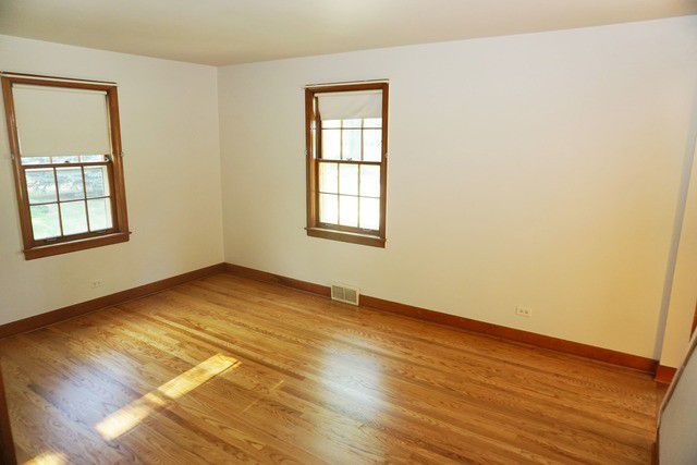 324 South Maple Street Itasca, IL 60143 - Photo 13 of 21 an empty room with wooden floor and windows