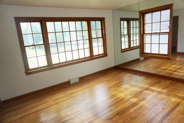 324 South Maple Street Itasca, IL 60143 - Photo 17 of 21 a view of an empty room with a window and wooden floor