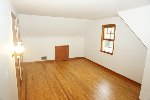 324 South Maple Street Itasca, IL 60143 - Photo 19 of 21 a view of a room with wooden floor and small window