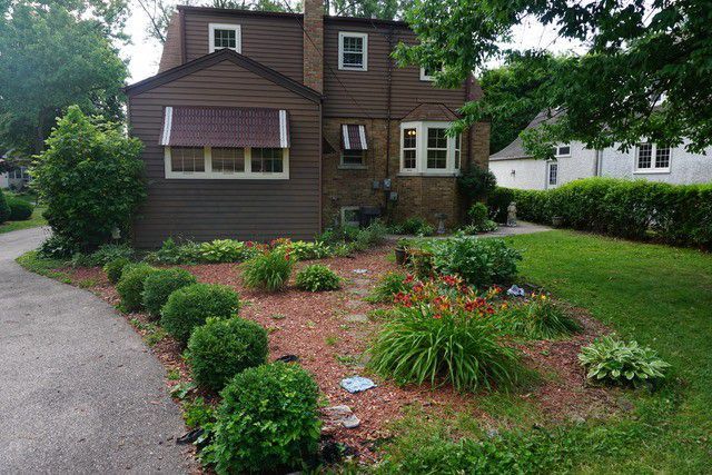324 South Maple Street Itasca, IL 60143 - Photo 3 of 21 a front view of a house with a garden