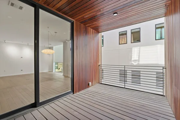 a view of a porch with wooden floor and a bathroom