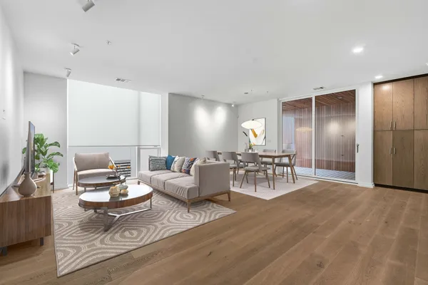 a living room with furniture and kitchen view