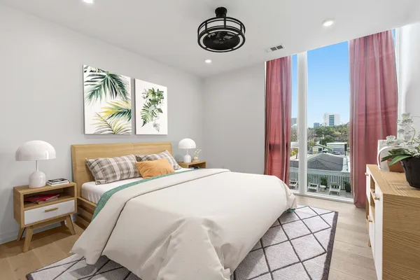 a bedroom with a bed and a chandelier