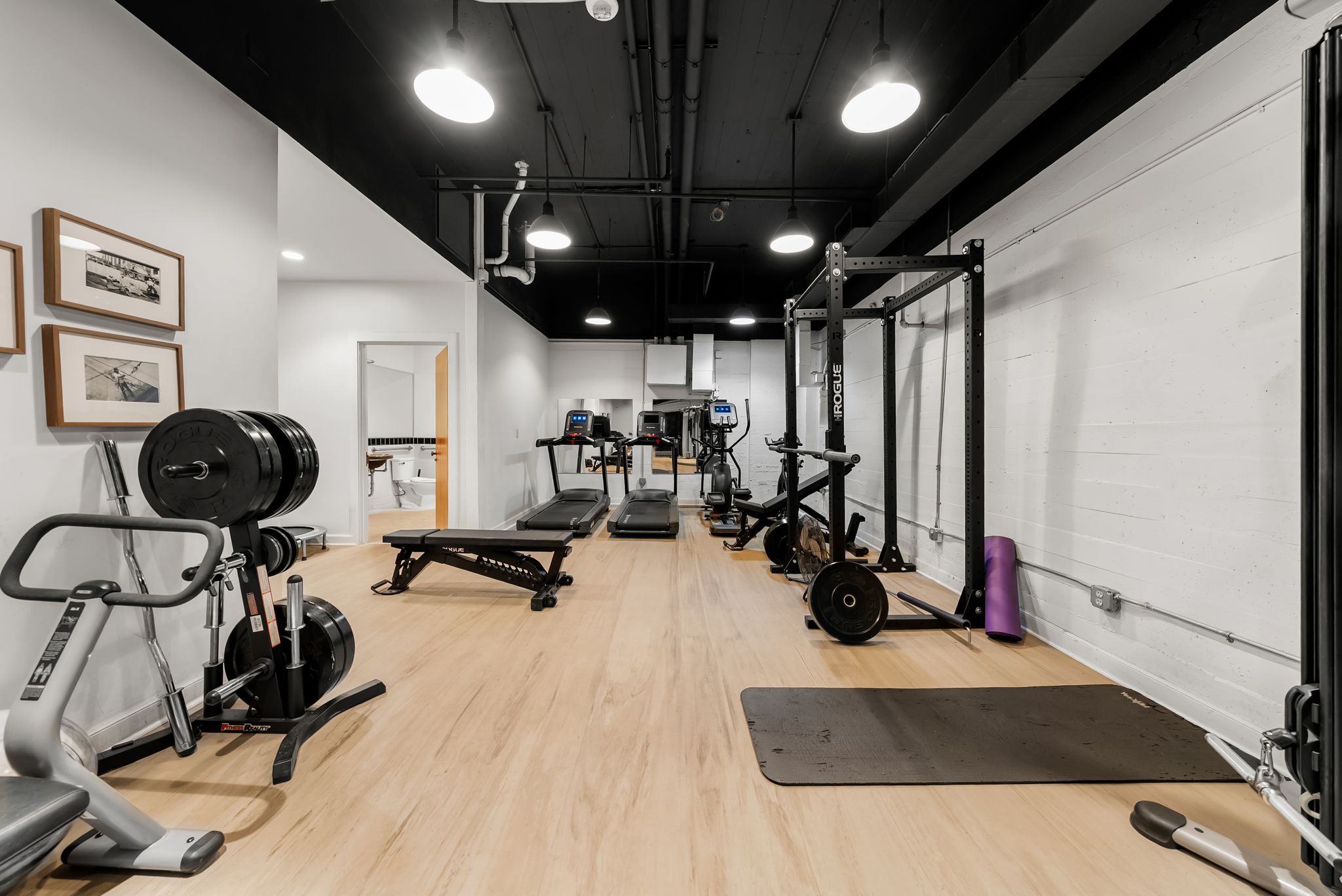 710 Colorado Street, Unit 6E Austin, TX 78701 - Photo 22 of 24 An ideal setup for fitness enthusiasts, this well-equipped gym space accommodates a range of exercise needs.