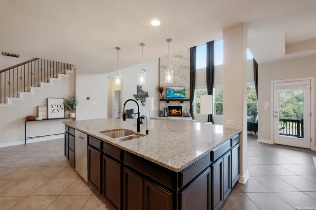 a kitchen with stainless steel appliances granite countertop a sink a oven and a refrigerator