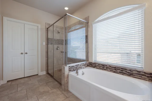 a bathroom with a bathtub and a shower
