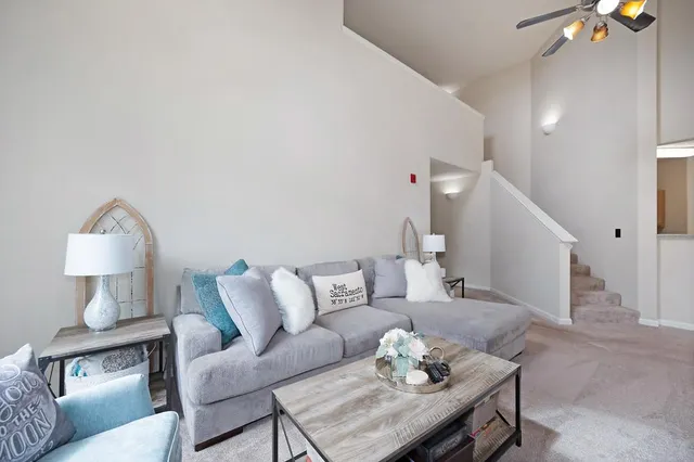 a living room with furniture and a lamp