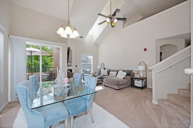 a living room with furniture chandelier and a large window