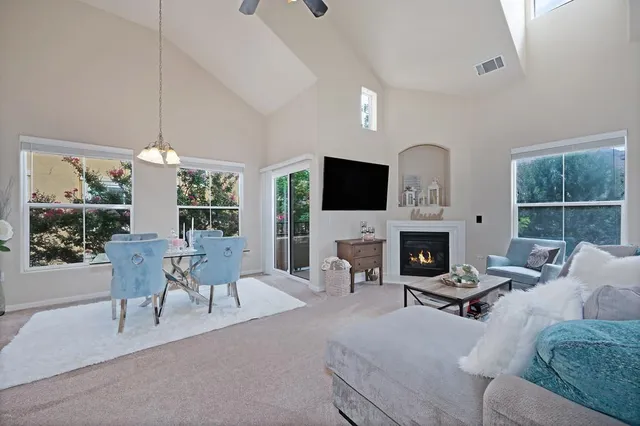 a living room with furniture a fireplace and a flat screen tv