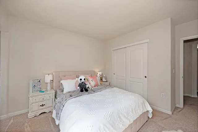 a bathroom with a granite countertop toilet and a sink