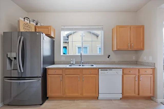 a kitchen with appliances a sink and a window
