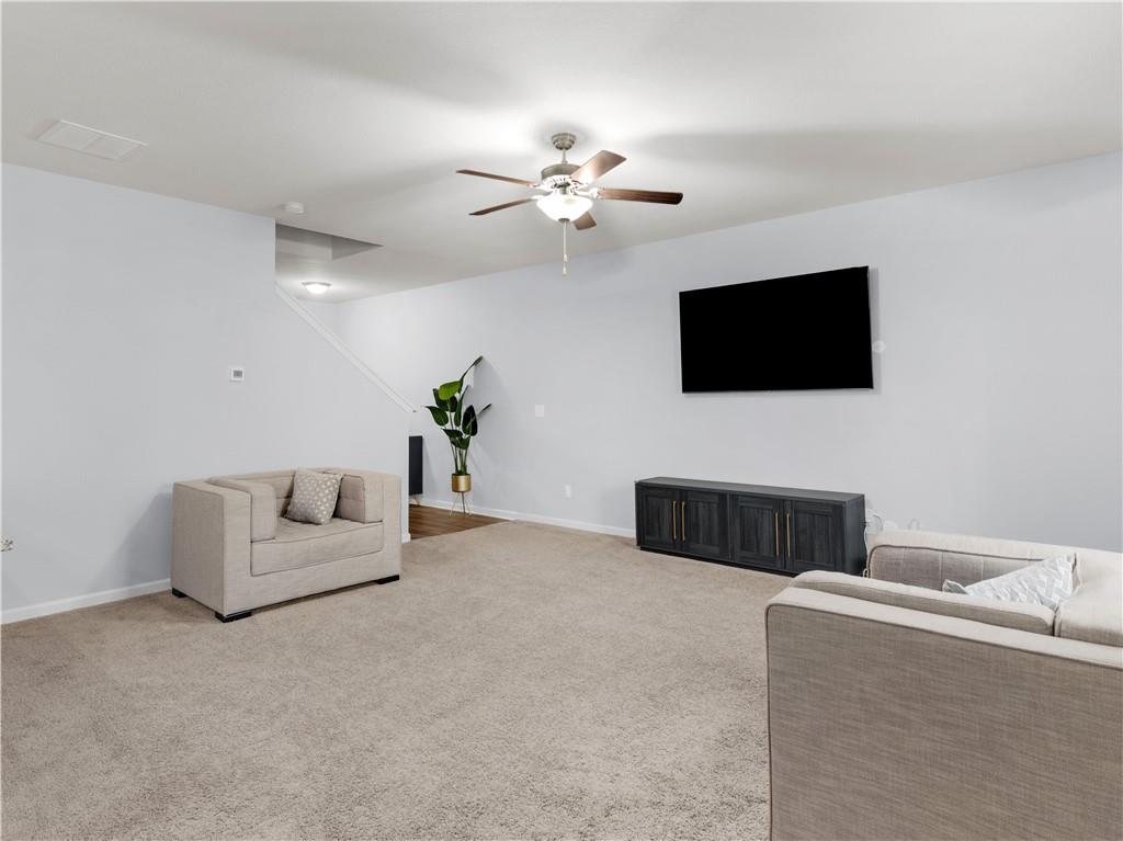 10891 Wheeler Trace Hampton, GA 30228 - Photo 11 of 45 a living room with furniture and a flat screen tv