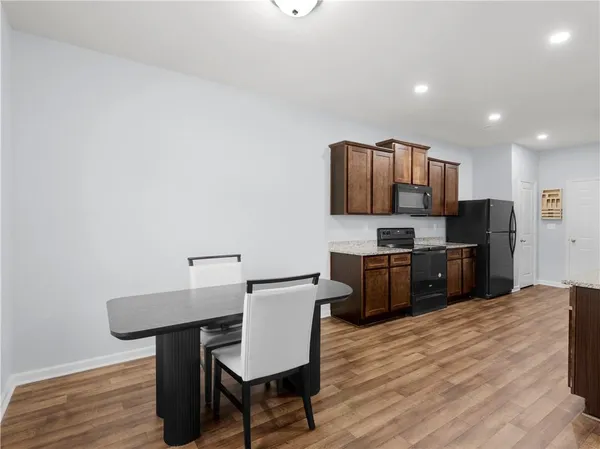 a kitchen with stainless steel appliances a microwave sink and refrigerator
