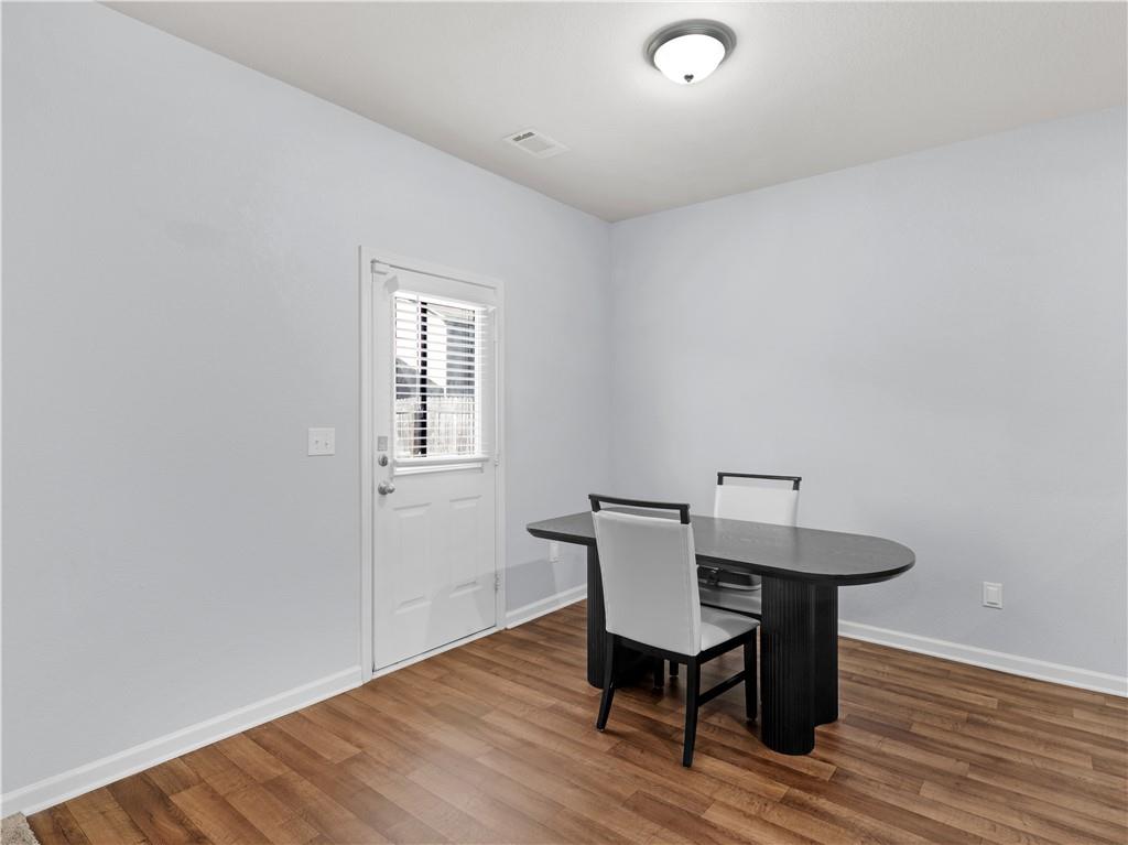 10891 Wheeler Trace Hampton, GA 30228 - Photo 14 of 45 a view of a dining room with furniture and wooden floor