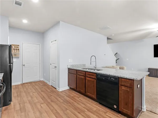 a kitchen with stainless steel appliances granite countertop a sink and cabinets