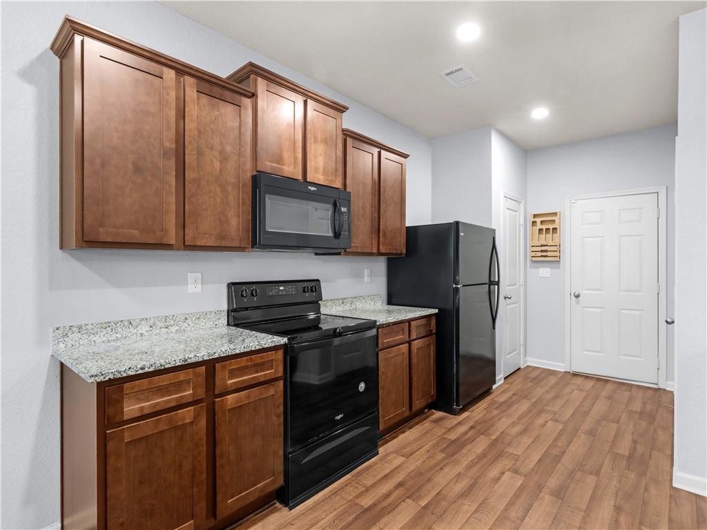 10891 Wheeler Trace Hampton, GA 30228 - Photo 18 of 45 a kitchen with stainless steel appliances granite countertop a refrigerator stove and microwave