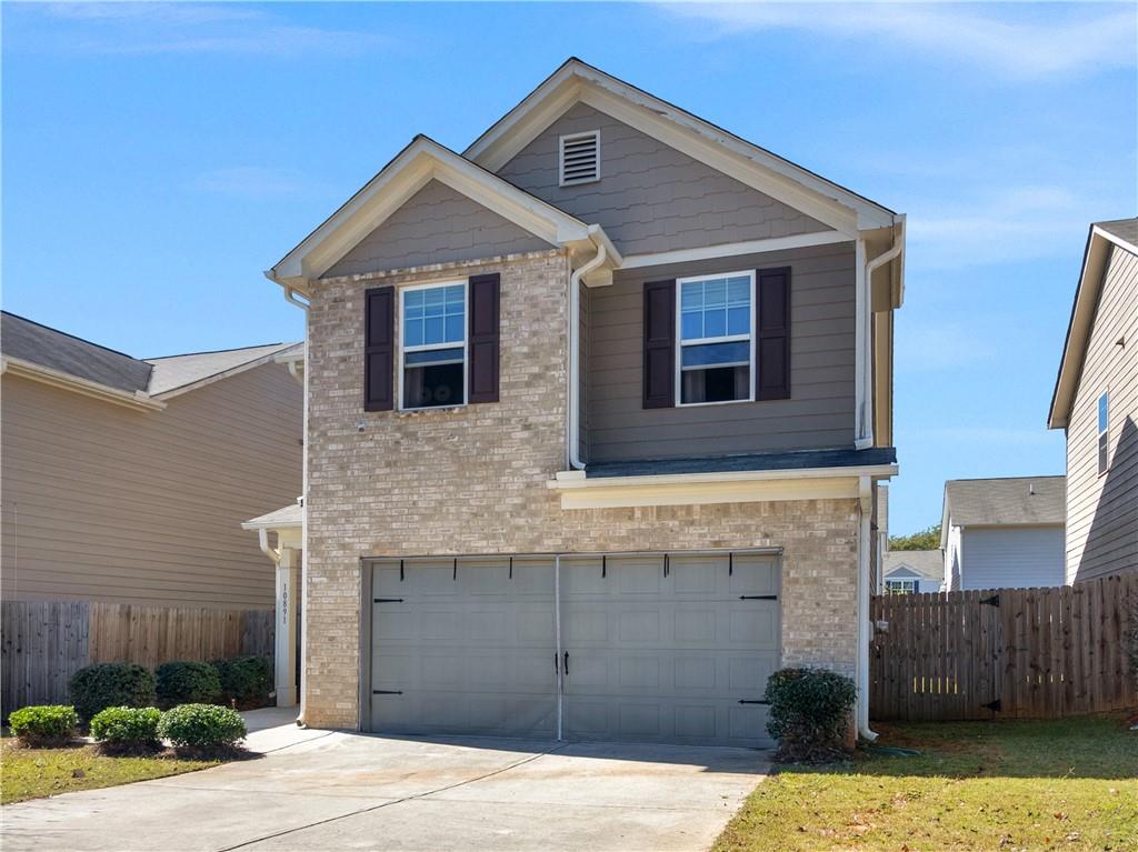 10891 Wheeler Trace Hampton, GA 30228 - Photo 2 of 45 a front view of a house with a yard
