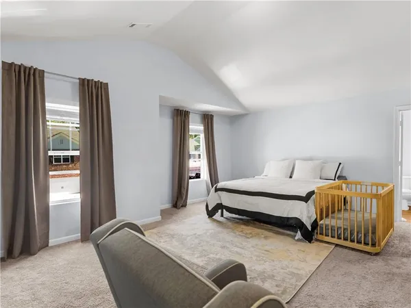 a bedroom with bed and a window