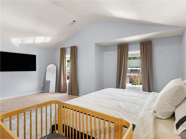 a bedroom with a bed and a flat screen tv