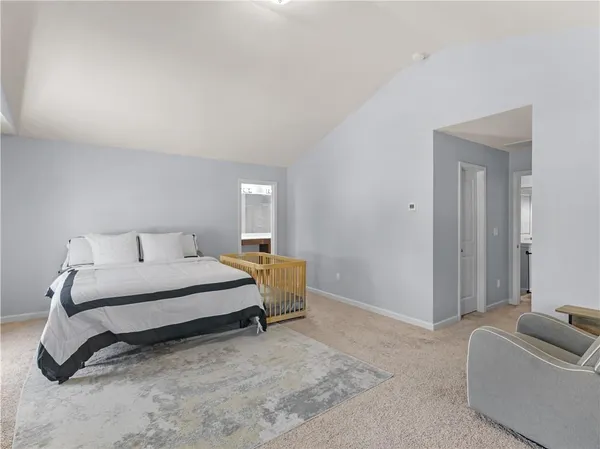 a spacious bedroom with a bed and couch