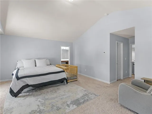 a spacious bedroom with a bed and couch