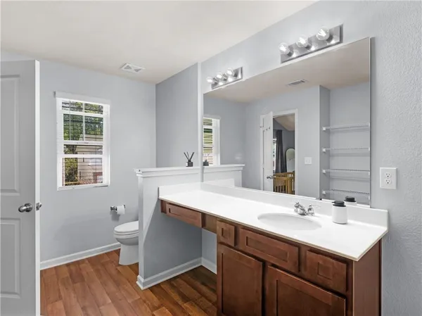 a bathroom with a sink double vanity granite and a mirror