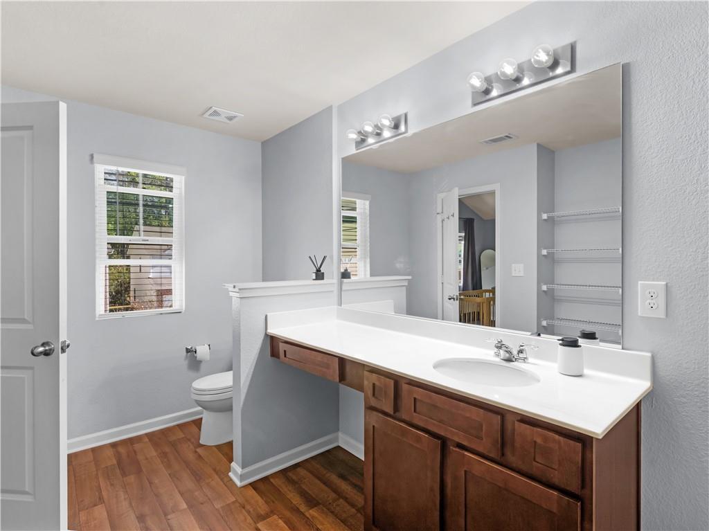 10891 Wheeler Trace Hampton, GA 30228 - Photo 26 of 45 a bathroom with a sink double vanity granite and a mirror