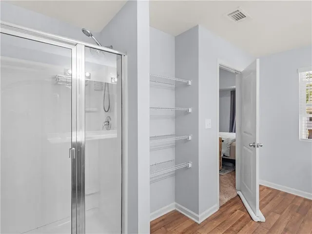 a bathroom with a glass shower door