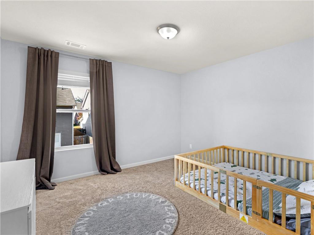 10891 Wheeler Trace Hampton, GA 30228 - Photo 32 of 45 a bedroom with furniture and a window