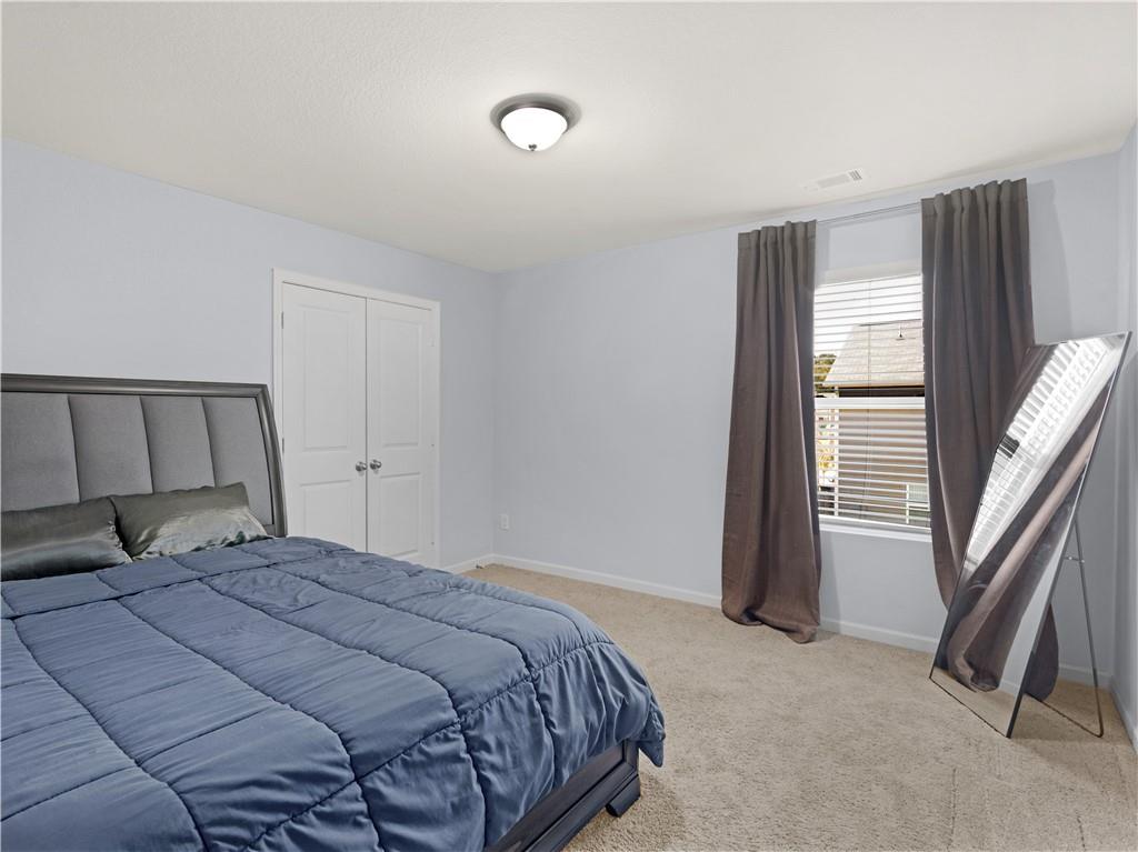 10891 Wheeler Trace Hampton, GA 30228 - Photo 35 of 45 a bedroom with a bed and a large window