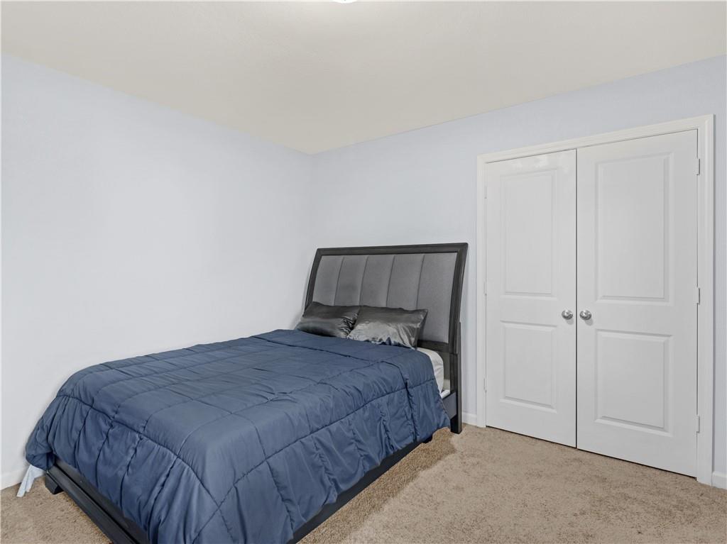 10891 Wheeler Trace Hampton, GA 30228 - Photo 36 of 45 a bedroom with a bed and a window