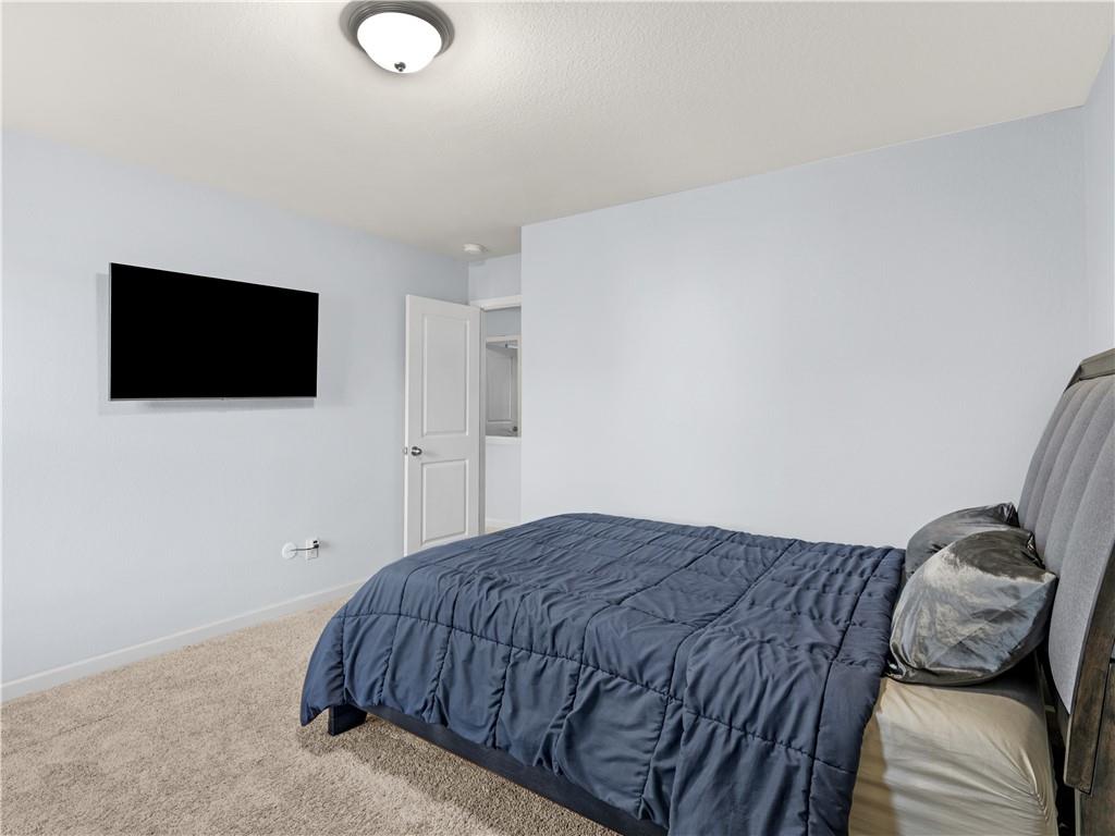 10891 Wheeler Trace Hampton, GA 30228 - Photo 37 of 45 a bedroom with a bed and a flat screen tv