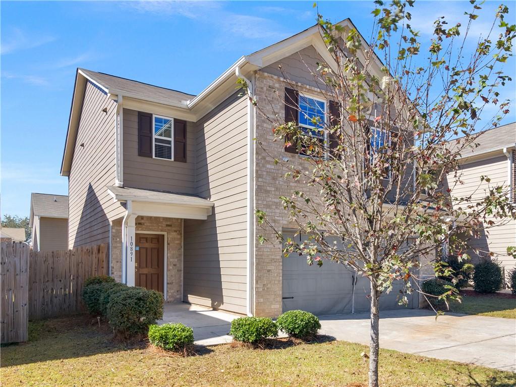 10891 Wheeler Trace Hampton, GA 30228 - Photo 4 of 45 a front view of a house with trees
