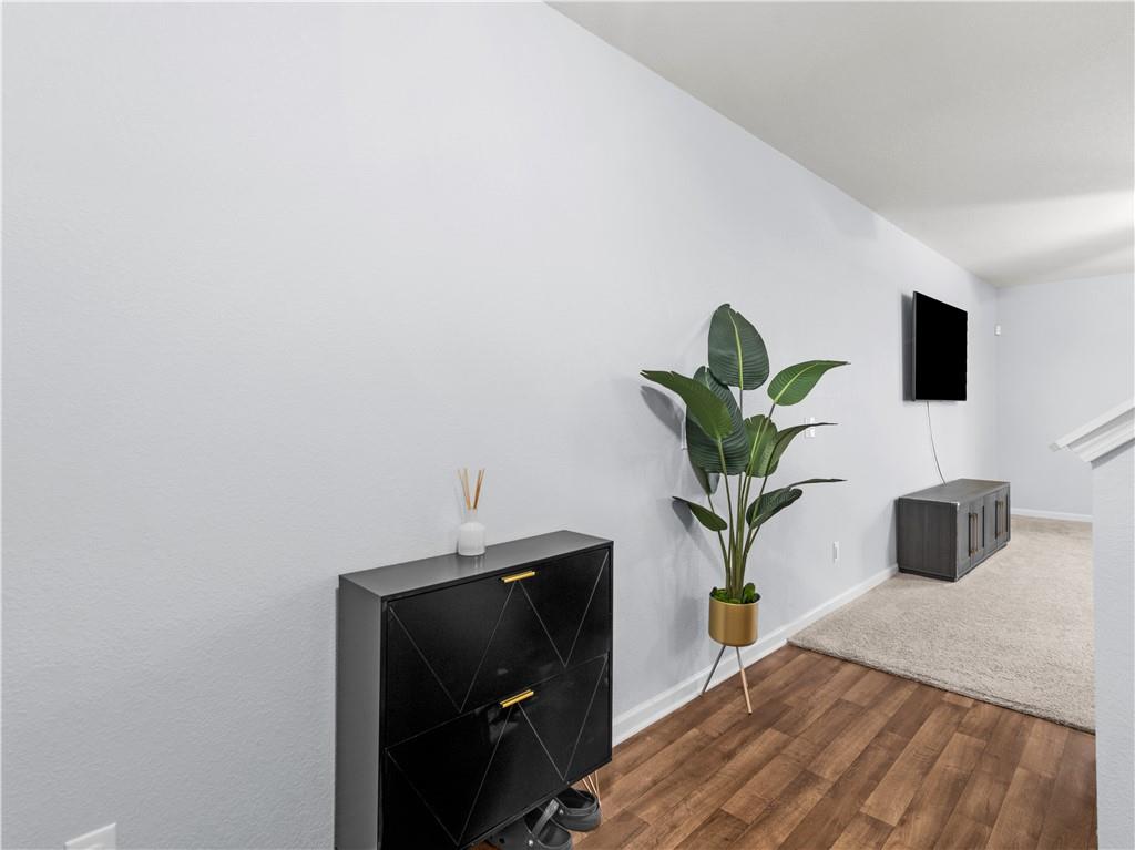 10891 Wheeler Trace Hampton, GA 30228 - Photo 5 of 45 a vase of flowers sitting on a bed