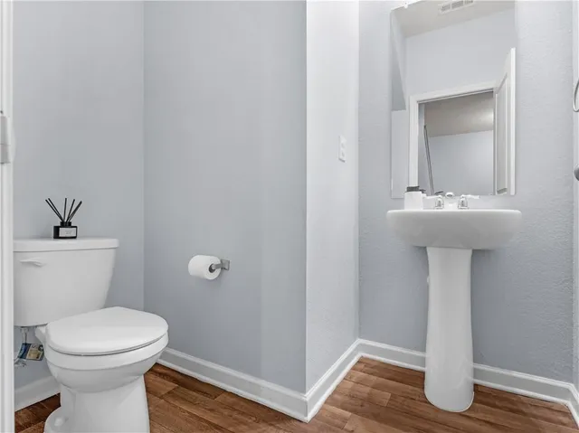 a bathroom with a sink a toilet and mirror