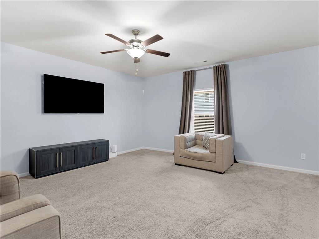 10891 Wheeler Trace Hampton, GA 30228 - Photo 10 of 45 a living room with furniture and a flat screen tv