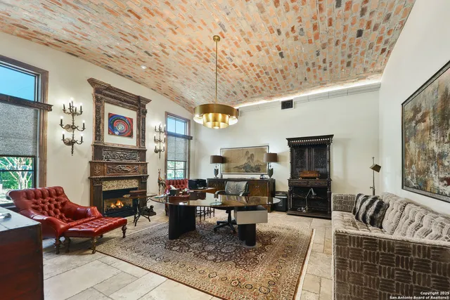 a living room with fireplace furniture and a flat screen tv