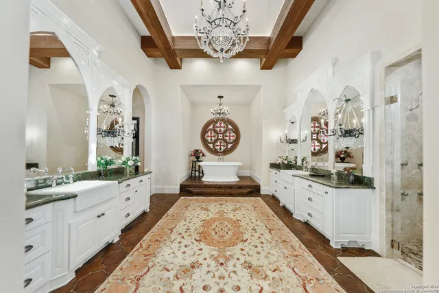 a spacious bathroom with double vanity sinks a mirror and a shower
