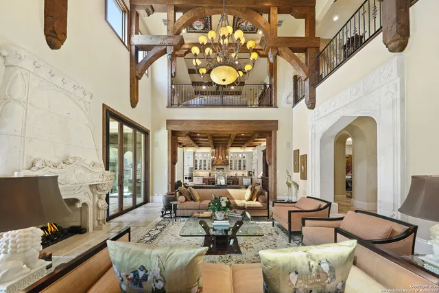 a living room with fireplace furniture and a large window