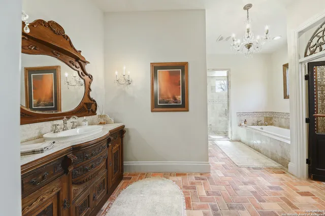 a bathroom with a sink a vanity a mirror and a bathtub