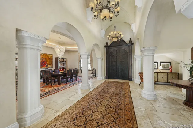 a living room with furniture and a chandelier