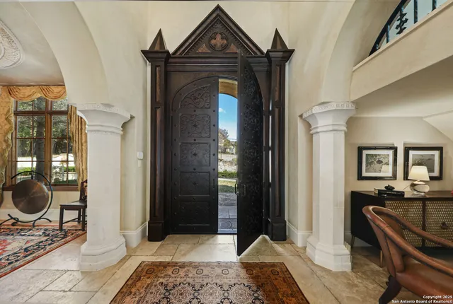 a living room with a fireplace furniture and a rug