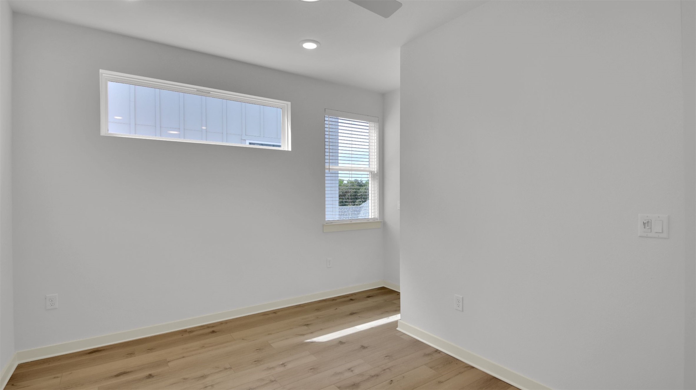 7208 Providence Avenue, Unit 1 Austin, TX 78752 - Photo 15 of 26 This room features light-colored walls, recessed lighting, and a ceiling fan